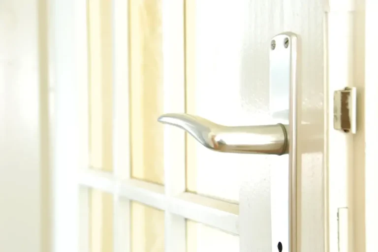 How to change a uPVC door lock in Chester – white door with a lever handle on a long backplate, Locksmith Chester guide to barrel, handle and multipoint replacement