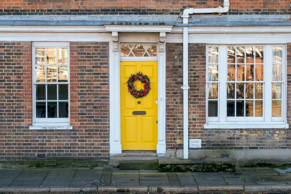Yellow front door on a red-brick Victorian house – residential locksmith Chester front door security check by Locksmith Chester